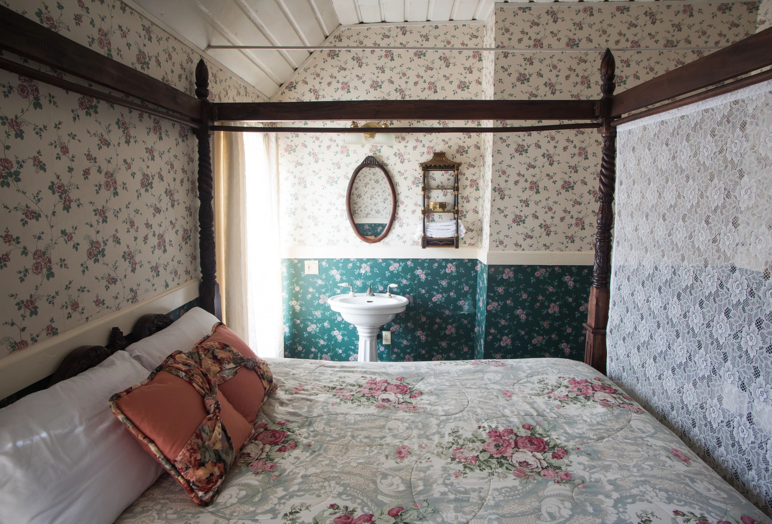 Cozy bedroom with floral decor and a vintage sink.