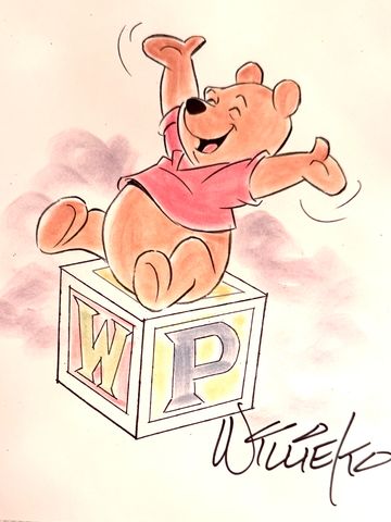 Winnie the Pooh happily sitting on a block with letters W and P.