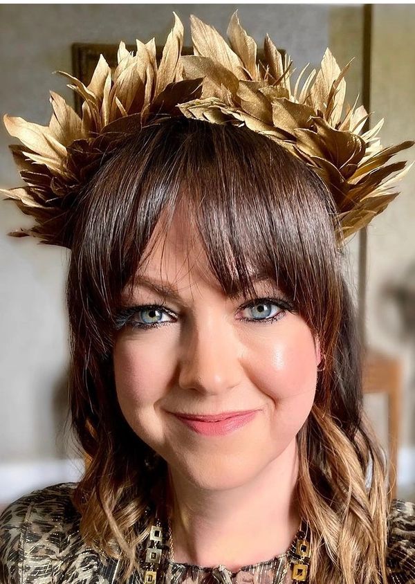 bride wearing feather flower crown