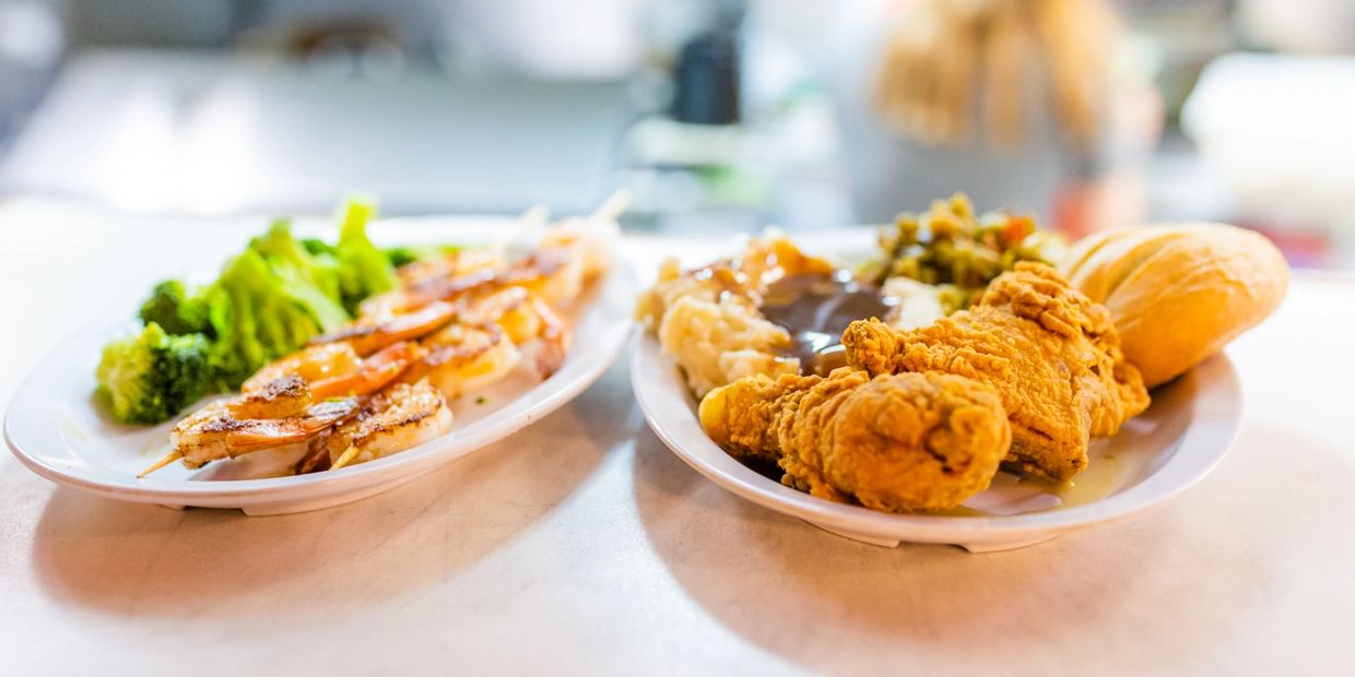 Two plates of food kept at the table