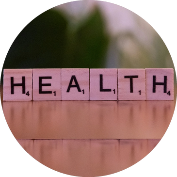 Scrabble tiles reading HEALTH arranged on top of a wall.