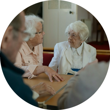 Four seniors participating in a resident council meeting.