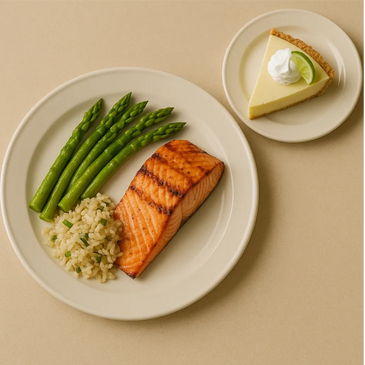 A nutritious meal of salmon, rice pilaf and aparagus spears with a slice of key lime pie for dessert