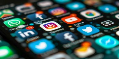 Close-up of a smartphone home screen showing popular social media app icons.