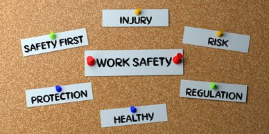Notes on a corkboard highlighting work safety and related terms.