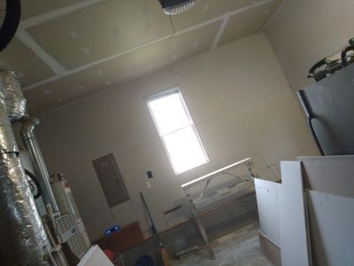 Drywall  being installed in a house.