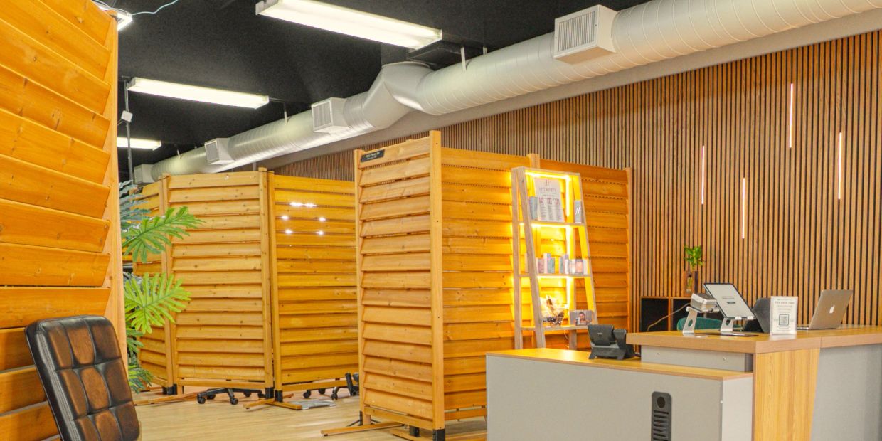 Modern office workspace with wooden partitions and desk.