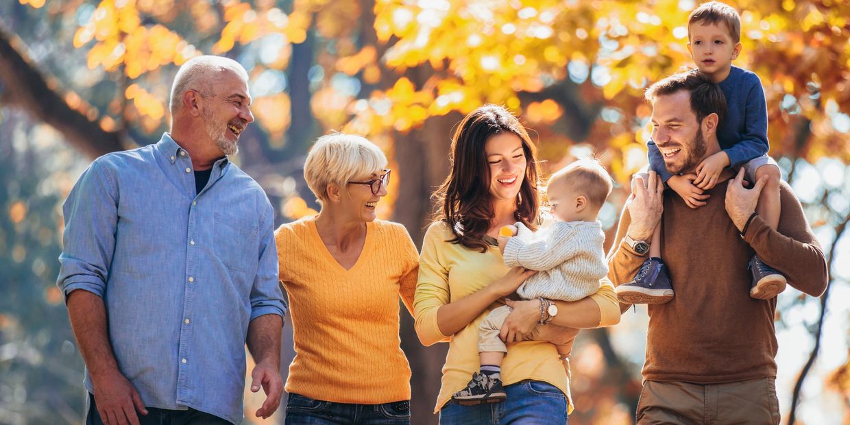 multi-generation family enjoying a walk in autumn