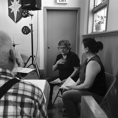 A group of people engaged in a discussion inside a room.
