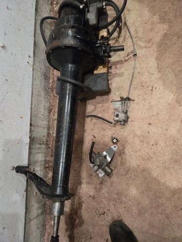 Old mechanical device or motor part on floor.