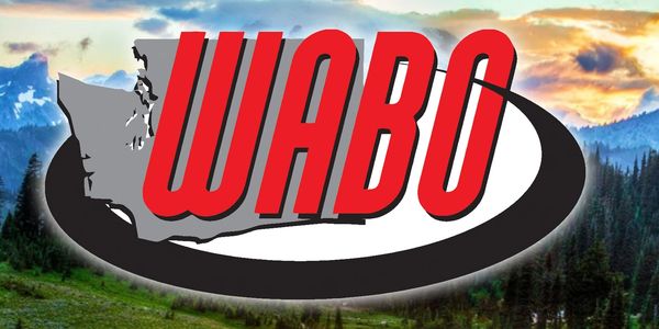 Logo of WABO over a scenic mountain landscape at sunset.
