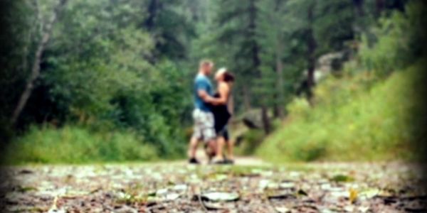 Couple embracing on O'Fallon Park hiking trail