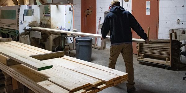 Employee loading wood into the Moulder machine