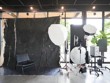 Professional photography studio setup with lighting and backdrop.
