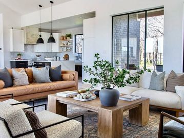 Modern living room with cozy seating and a wooden coffee table.
