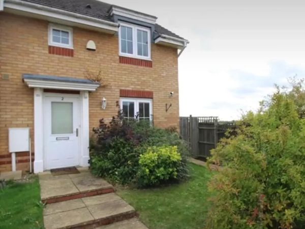 Brick house with garden in front.
