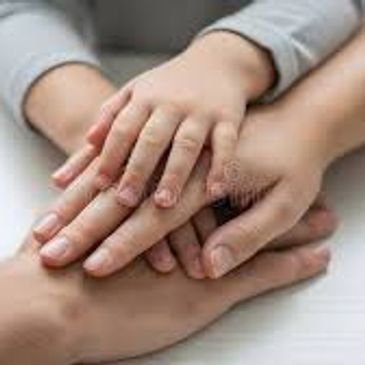 Multiple hands stacked together symbolizing unity and support.