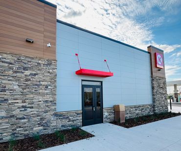 a circle k gas station with red metal awnings and brown metal awnings