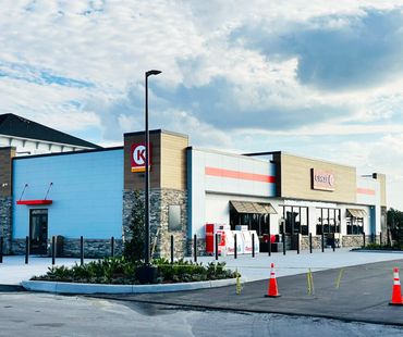 a circle k gas station with red metal awnings and brown metal awnings