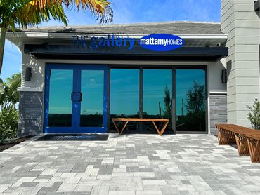 a black metal awning with a blue sign in front that states the gallery mattamy homes
