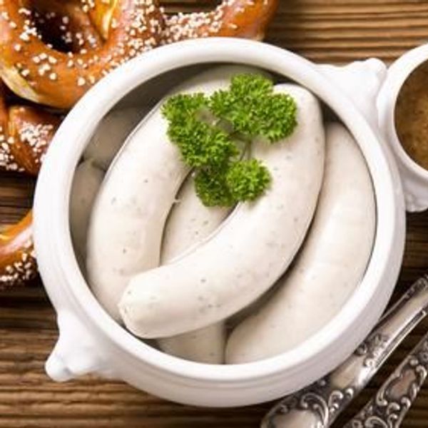 Traditional Bavarian white sausages with pretzels and mustard.