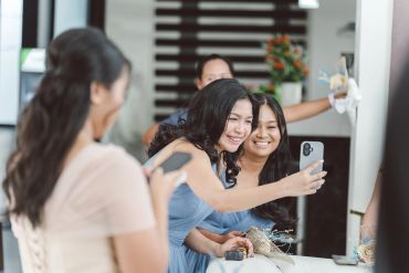Two women smiling and taking a selfie together.