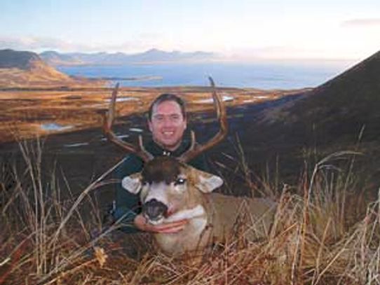 Picture of a Close Encounters Bowhunts client with a Sitka Blacktail buck taken on Kodiak Island