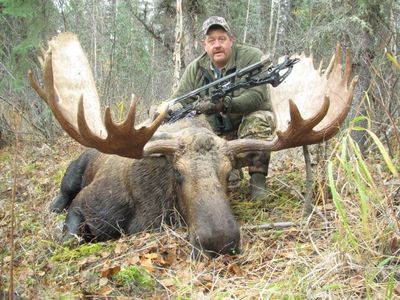 Picture of a Close Encounters Bowhunts client with an archery bull moose