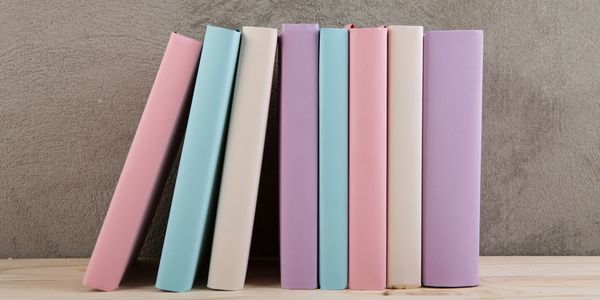 Neutral-toned book stack symbolizing curated storytelling and thoughtful content creation.