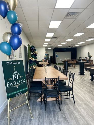 Interior of The 19th Parlor with tables, chairs, and balloons.