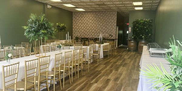 Elegant banquet room with gold chairs and white tablecloths.