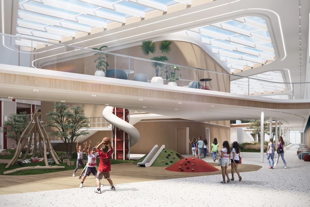 Children playing in a modern indoor playground with natural light and greenery.
