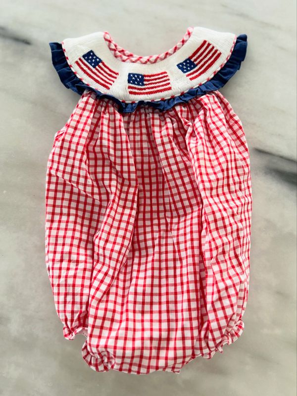 A red and white checkered baby romper with American flag embroidery.