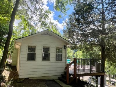 Outdoors of yellow Cedars Cabin surrounded by trees, Star Point Resort on Dale Hollow Lake
