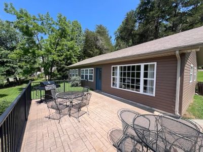 Deck with patio table, chairs and grill outside Chestnut cabin at Star Point Resort on Dale Hollow L