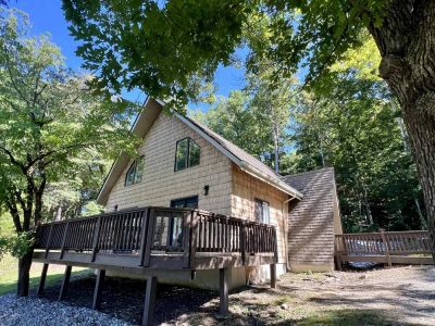 Dogwood cabin exterior beneath tall trees at Star Point Resort on Dale Hollow Lake
