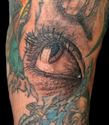 Detailed eyeball tattoo with shading and surrounding colors.