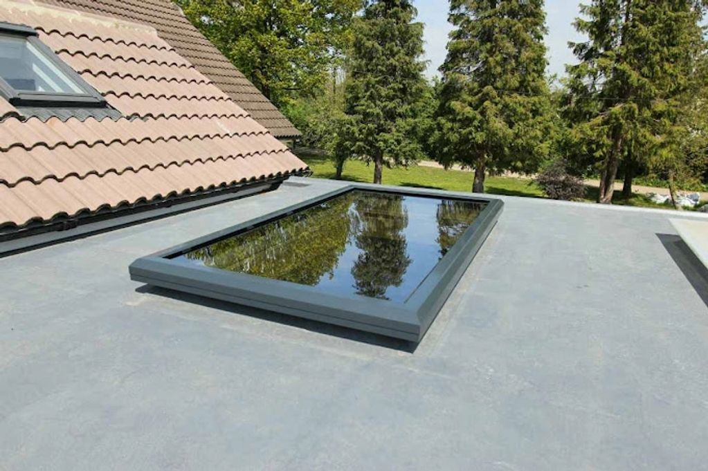 grey alumnium flat glazed roof lantern on a flast roof