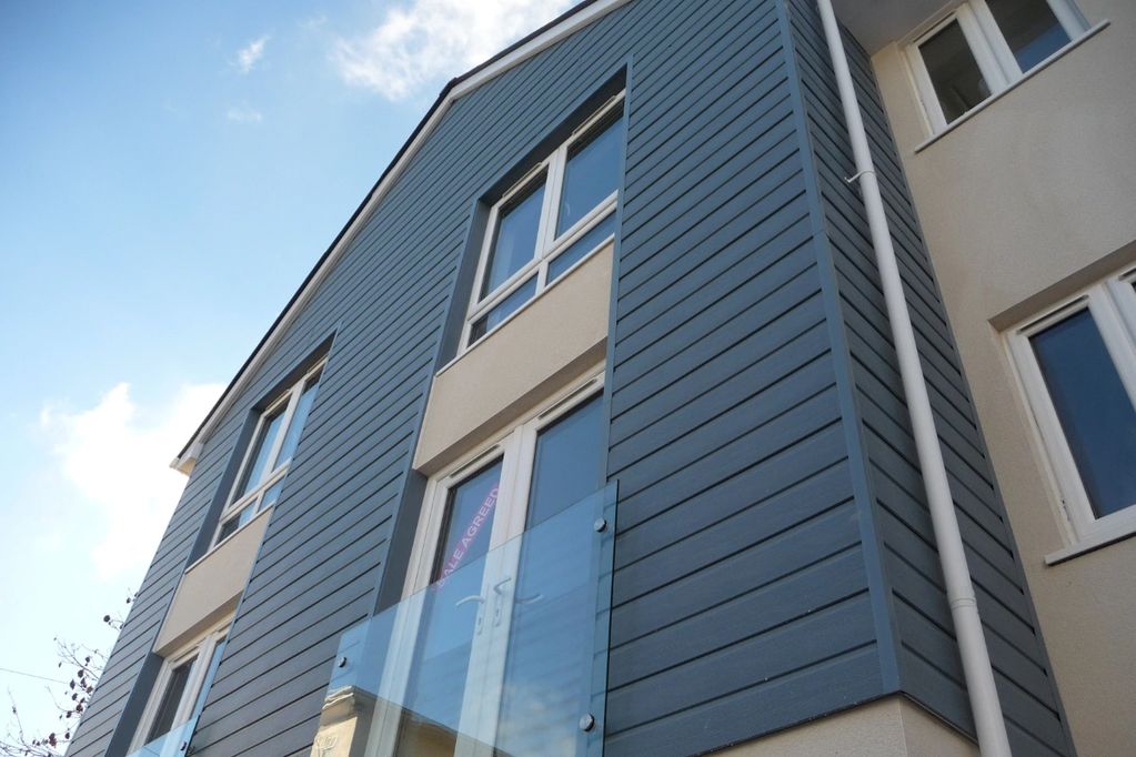 outside of a house with new fascias, soffits and cladding. New white upvc windows & doors