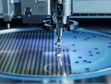 A robotic arm inspects or assembles microchips on a silicon wafer in a high-tech lab.