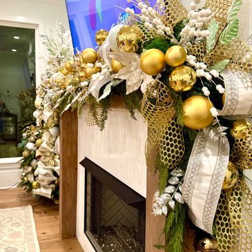 Luxurious gold and white Christmas garland decorates a fireplace mantle.