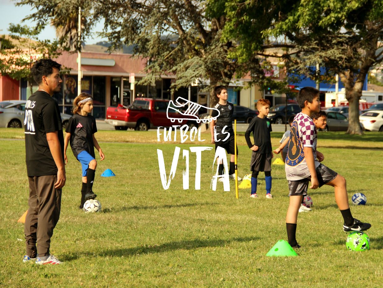 Kids practice soccer on a sunny field with a coach nearby, emphasizing that soccer is life.