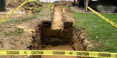 Trench for liquid propane tank relocation with new gas service.