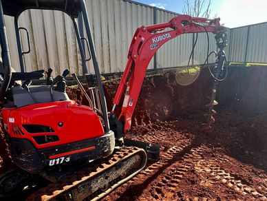 Drilling postholes with mini excavator 