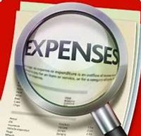 Magnifying glass highlighting the word 'EXPENSES' on a financial document.