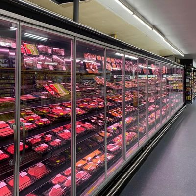 Refrigerated meat section in a grocery store with various packaged meats.