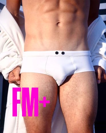 Man in white briefs and robe showing toned body.