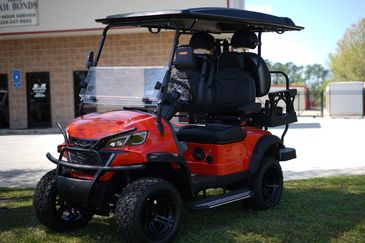 Red 4 seat golf cart with windshield, battery powered