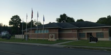 Police station with flags at dusk.