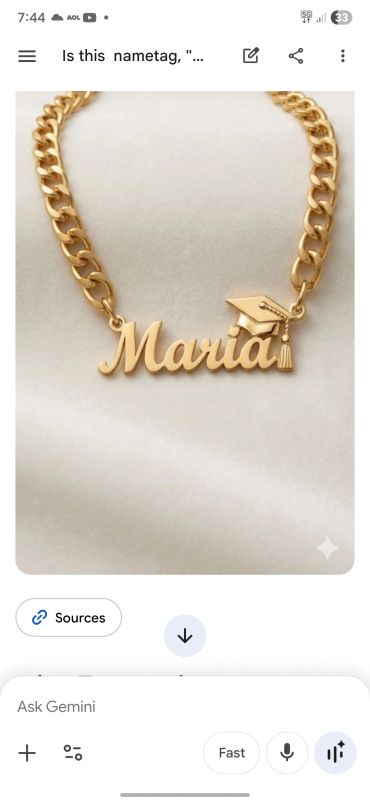 Gold name necklace with "Maria" and a graduation cap charm.